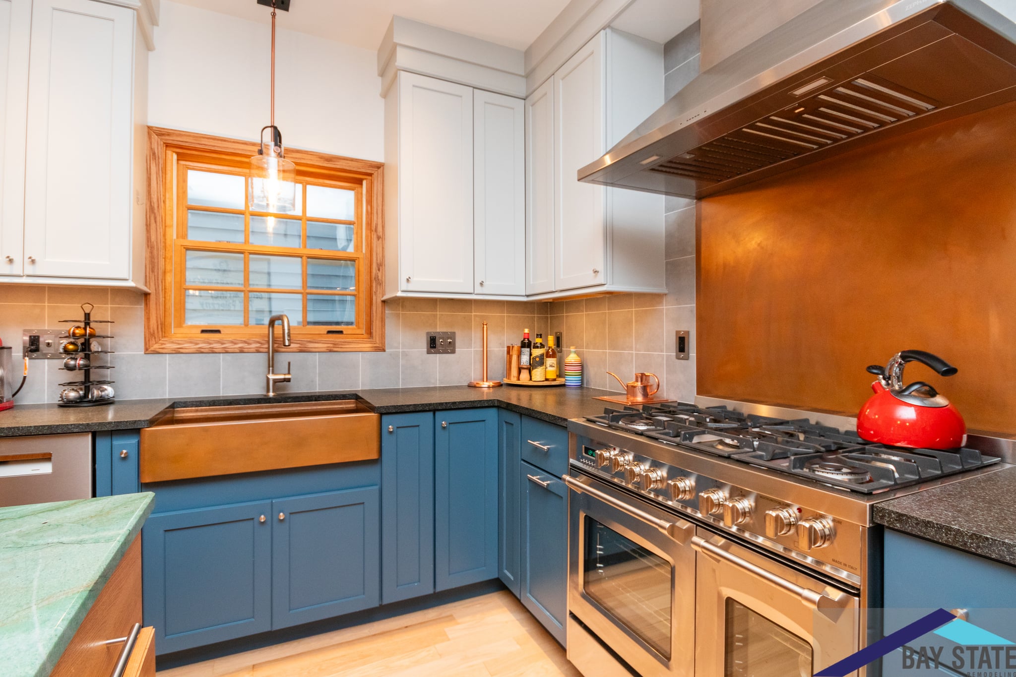 Newly remodeled kitchen with white cabinets, modern appliances, and a large kitchen island with a white countertop.